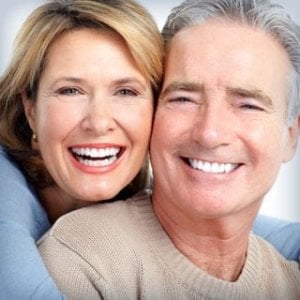 A smiling adult couple with beautiful healthy teeth